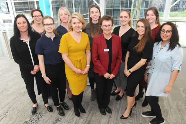 Schoolgirls at a 2020 event, organised by EBP South, featuring 10 inspirational women who talked about their careers. Pictured is: (in red jacket) Cath Longhurst, chief executive of EBP South, with the 10 inspirational women. Picture: Sarah Standing (100320-7055)