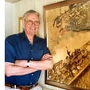Former News chief photographer Roy West beside his most famous picture, HMS Vanguard after she almost ran aground at Point, Old Portsmouth.