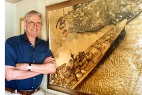 Former News chief photographer Roy West beside his most famous picture, HMS Vanguard after she almost ran aground at Point, Old Portsmouth.