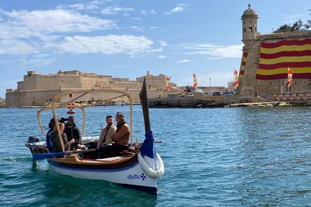 Richard E. Grant on boat in Malta talking to guide. The film star visited the island for his new Channel 4 series Richard E Grant's Modern Odyssey. (Picture: Emporium Productions)