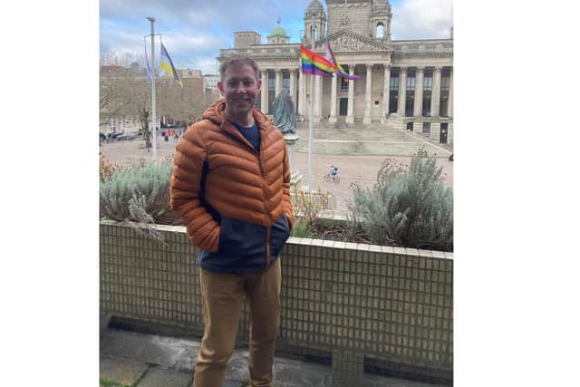 Councillor Chris Atwell with the pride flags in front of the Portsmouth City Council offices. Picture: PCC