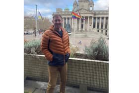 Councillor Chris Atwell with the pride flags in front of the Portsmouth City Council offices. Picture: PCC