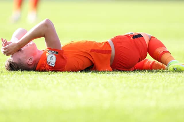 Ronan Curtis on the ground injured after suffering a knock at Rochdae. Picture: Charlotte Tattersall/Getty Images