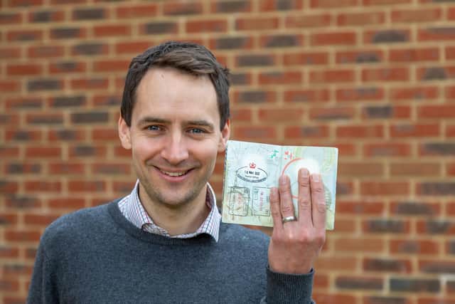 Daniel Blackman with the passport stamp he recieved in Liechtenstein, which marked the completion of his European travels. Picture: Mike Cooter (140422)