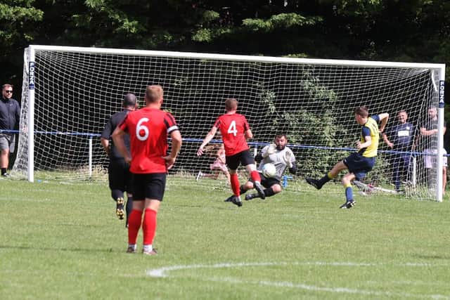 Moneyfields striker Will Porter puts  his side ahead at Paulsgrove on Bank Holiday Monday. Picture: Sam Stephenson.