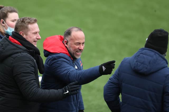 Fleet's head of performance Lee Taylor points angrily at Hawks boss Paul Doswell, with Fleet manager Dennis Kutrieb on the left. Photo by Dave Haines