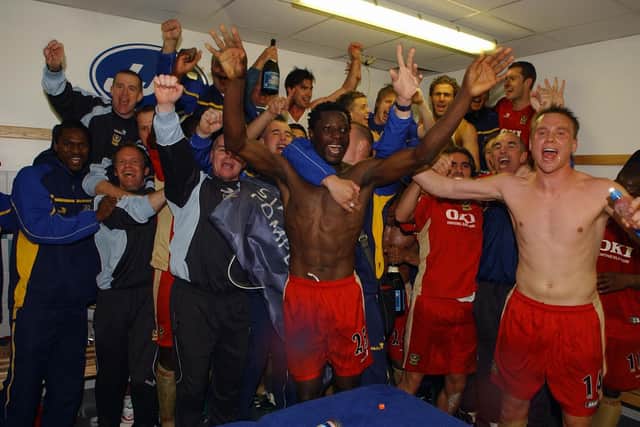 Matt Taylor (far right) and a jubilant Pompey dressing room celebrate the 2-1 win at Wigan in April 2006 which preserved the Blues' Premier League status. Picture: Steve Reid