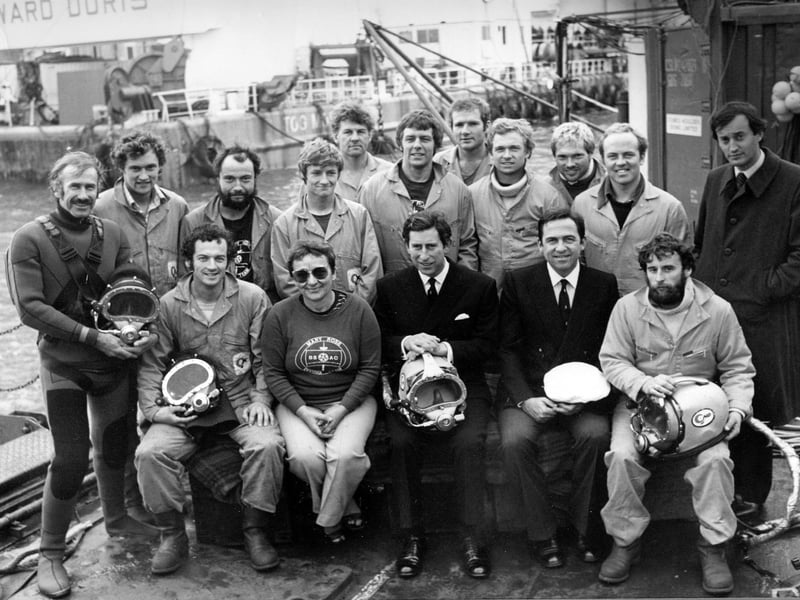 Most of the Mary Rose Salvage and Recovery Team with Margaret Rule, the then HRH Prince Charles, King Constantine of the Hellenes (seated) and Lord Romsey standing. Back row, left to right: David Burden, Christopher Dobbs, Paul Chisholm, Simon Jones, Charles Pochin, Peter Ewens, Nick Thompson, Martin Icke, Martin Freeman, Kester Keighley. Front row: Jonathan Adams (far left), Christopher Underwood (far right). October 10 1982.