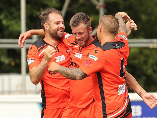 Brett Pitman congratulated by Ashton Leigh and Jake Raine following his equaliser. Picture by Dave Haines