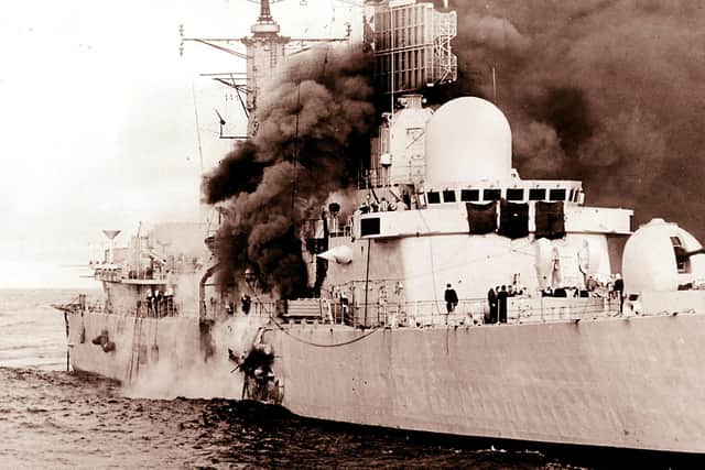 HMS Sheffield burns shortly after being hit by an Argentine Exocet missile, on 4/5/1982, whilst on radar picket duties off the coast of the Falkland Islands.