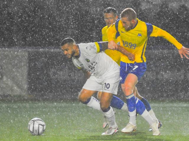 Hawks' Billy Clifford and Torquay's Connor Lemonheigh-Evans battle for possession as the rain lashes down at Westleigh Park. Picture: Martyn White