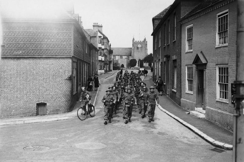 British Invasion troops waiting for D-Day marching through a village street, 28th May 1944. (Photo by Reg Speller/Fox Photos/Getty Images)