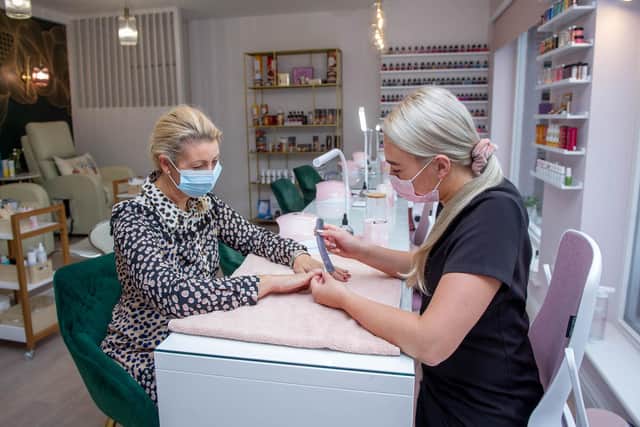 Sam Frost getting her nails done by Ellie Caplen, assistant manager. Picture: Habibur Rahman.