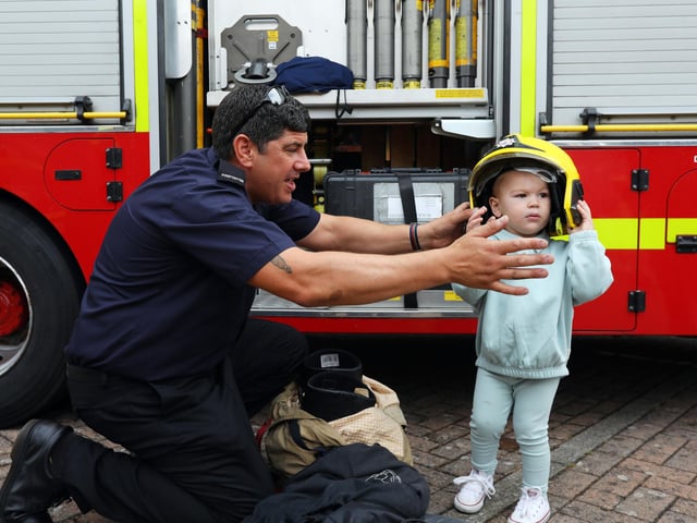 Firefighter Phil 'Larry' Lamb helps Louie Wiggins, 2, try on a firefighter's helmet. 999 Day at Port Solent
Picture: Chris Moorhouse (jpns 030922-08)