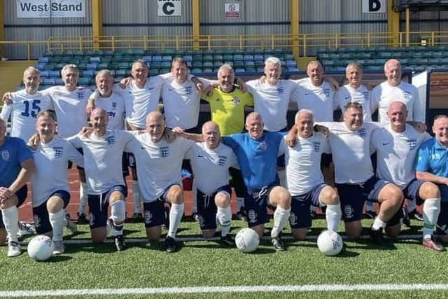 The triumphant England Over-55s team, featuring Chris Burns (front row second from right)