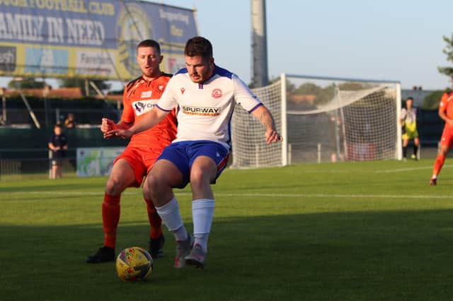 AFC Portchester's Lee Wort (orange) shadows Bradley Lethbridge during the 2-2 Ray Stainton/Steve Woods Memorial Cup draw at Privett Park last Friday. Picture: Tom Phillips.