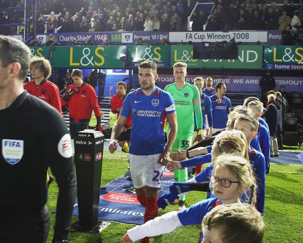 Captain Gareth Evans leads out Pompey against Arsenal. Picture: Joe Pepler