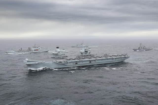 HMS Queen Elizabeth pictured alongside some of her task group. Photo: Royal Navy