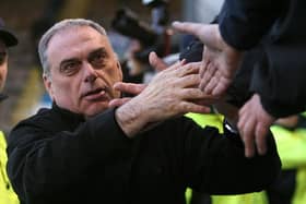 Avram Grant is mobbed at Burnley's Turf Moor