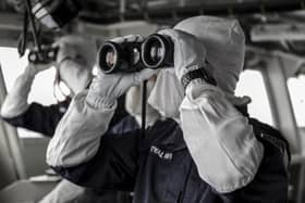 Pictured:  Personnel on the Amphibious ship HMS Albion wearing anti-flash clothing as they run through exercises with a Dutch aircraft for an air defence exercise