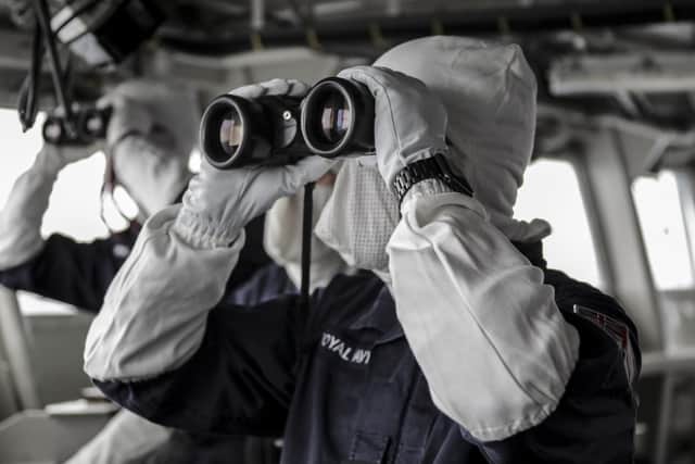 Pictured:  Personnel on the Amphibious ship HMS Albion wearing anti-flash clothing as they run through exercises with a Dutch aircraft for an air defence exercise