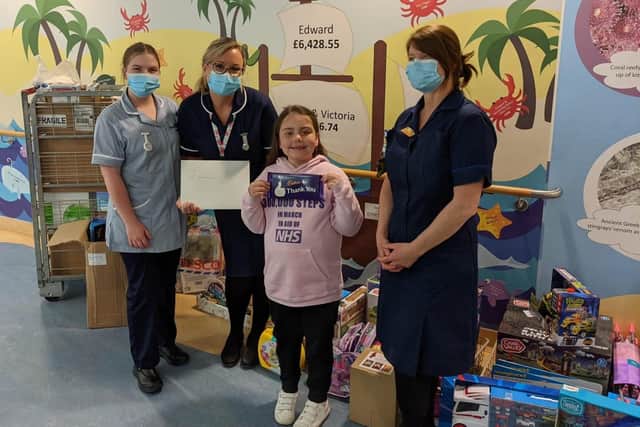 India-Rose handing over the donations to staff from Starfish ward
