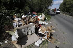 Fly-tipped rubbish and waste is seen beside a road in Colnbrook, near Heathrow, west of London on May 11 2020.
