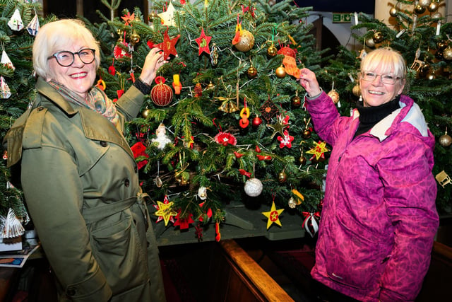 Pictured is: Carol Lindsey with Shirley Wenham admire the Lowry Girls Choir Tree


Picture: Keith Woodland (071221-4)