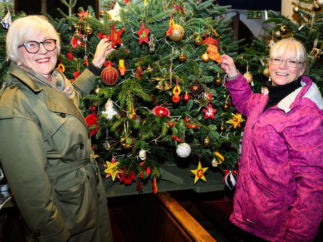 Pictured is: Carol Lindsey with Shirley Wenham admire the Lowry Girls Choir TreePicture: Keith Woodland (071221-4)