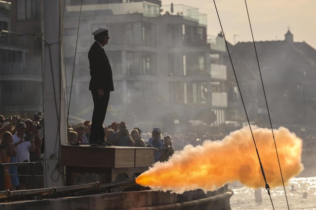 A gun salute takes place from the Royal Yacht Squadron as HMS Queen Elizabeth enters the Solent off of Cowes.