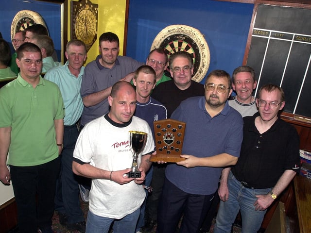 The Diamond Pub darts team show off their Portsmouth Monday League and Len Gilbert Cup trophies in 2005.
