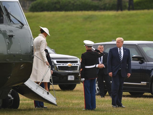 US President Donald Trump (R) and First Lady Melania Trump (L) disembark from the Marine One helicopter after arriving at Southsea Castle.