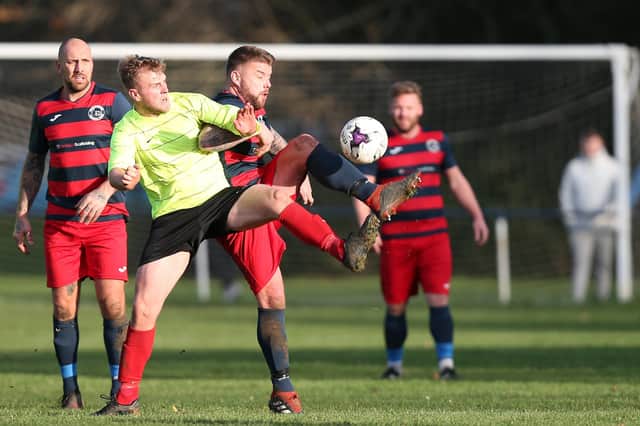 Paulsgrove (blue/red) take on Bush Hill in December - the Hampshire Premier League season could be set to resume in April following the Government's announcement that grassroots football can restart on March 29. Picture: Chris Moorhouse