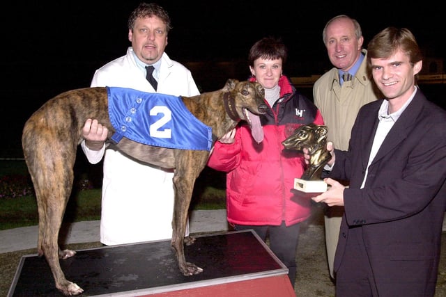 Golden Muzzle - Winner Jicky (No. 2) with kennel hand Nigel Wareham (left),  trainer Brian Clemenson (far right) and assistant trainer Carolyn Sallis (centre), receiving the trophy from Peter Shrees (right) after final at Portsmouth Greyhound Stadium,  Target Road, Tipner. Picture: Mike Scaddan. 005949_0067