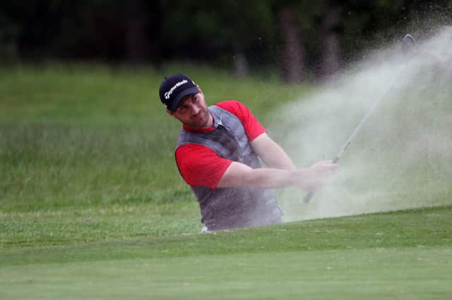 Hayling's Toby Burden splashes out of a greenside bunker during the final of the 116th Hampshire, Isle of Wight and Channel Islands Amateur Championship, against La Moye's Jo Hacker at North Hants GC. Picture: ANDREW GRIFFIN / AMG PICTURES