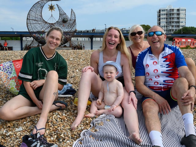 Pictured is: A happy family enjoying their day out on the beach.