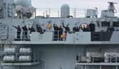 The crew of HMS Lancaster wave to family and friends at the entrance to Portsmouth Harbour.