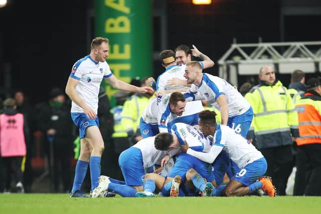 Pompey's players mob Andre Green following his stoppage-time winner at Norwich in January 2019. Picture: Joe Pepler