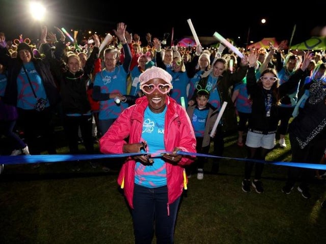Gloria Miller, cutting the ribbon to start The Alzheimer's Society Glow Walk at Castle Field, Clarence Esplanade, Southsea, Portsmouth, which attracted hundreds of walkers. 18th March 2022
Picture by Andrew Higgins/Thousand Word Media
