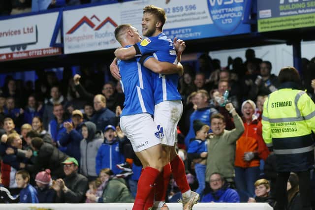 Lee Brown embraces Michael Jacobs after the winger netted Pompey's leveller on a rare League One start. Picture: Joe Pepler
