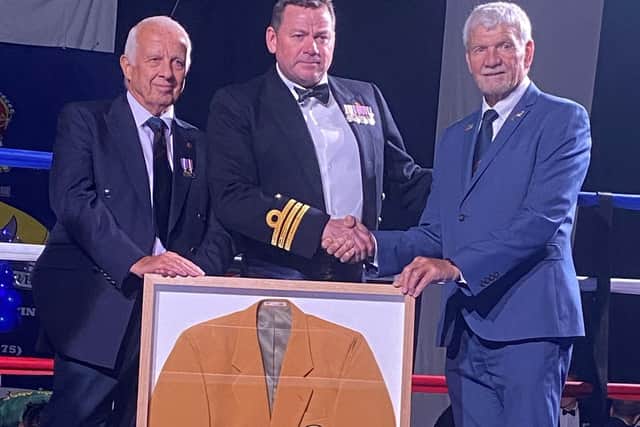 Tony Bevel, Leo Toms and Harry Rednapp present HMS Nelson with Crd Rod Robertson’s Commonwealth Games blazer