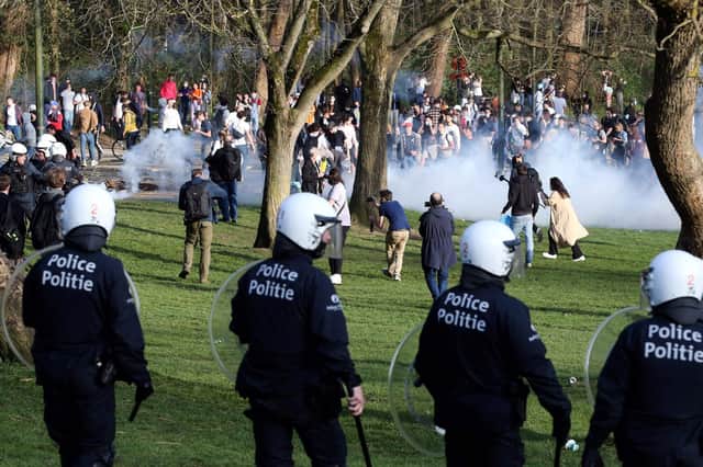 Belgian police officers surround bystanders at the Bois de la Cambre park, in Brussels, last week. Picture: AFP via Getty