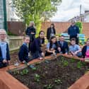 Megan Patten, Kell Swift and Kelly Prior with some of Copnor School pupils and headteacher, Matt Johnson, at the transformed garden at Copnor Primary School. Picture: Habibur Rahman
