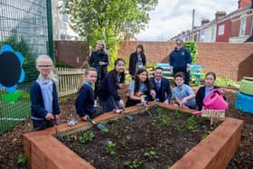 Megan Patten, Kell Swift and Kelly Prior with some of Copnor School pupils and headteacher, Matt Johnson, at the transformed garden at Copnor Primary School. Picture: Habibur Rahman