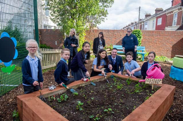 Megan Patten, Kell Swift and Kelly Prior with some of Copnor School pupils and headteacher, Matt Johnson, at the transformed garden at Copnor Primary School. Picture: Habibur Rahman