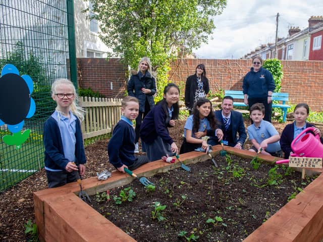Megan Patten, Kell Swift and Kelly Prior with some of Copnor School pupils and headteacher, Matt Johnson, at the transformed garden at Copnor Primary School. Picture: Habibur Rahman