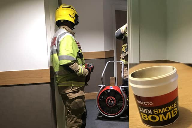 Firefighters from Cosham pictured using a fan to clear the haze left after an insecticide smoke bomb was used in a flat in Hilsea. Inset: the spent bottle of insecticide.