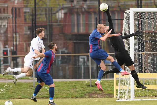 USP goalkeeper Tom Price almost collides with defender Harry Birmingham, while Binfield skipper Sean Moore and Jack Chandler look on. Picture: Keith Woodland