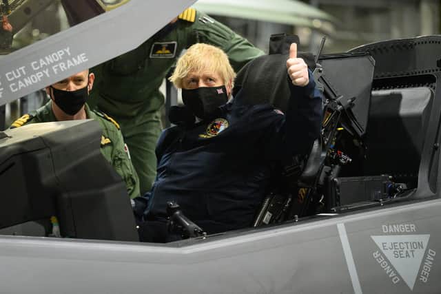 Prime Minister Boris Johnson sits in the cockpit of an Lockheed Martin F-35 Lightning II during a visit to HMS Queen Elizabeth aircraft carrier in Portsmouth this month. (Photo by Leon Neal - WPA Pool/Getty Images)
