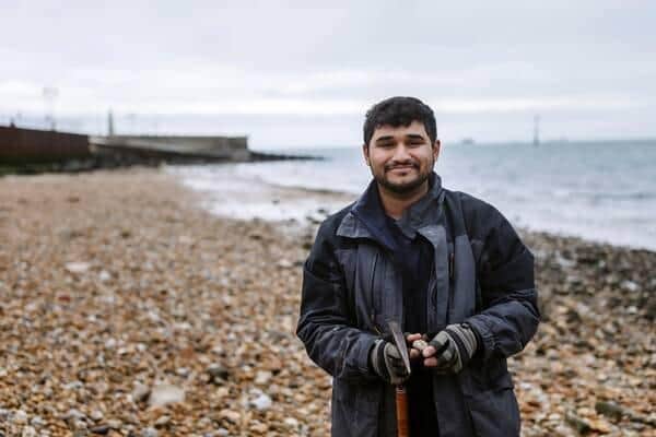 Hamzah Imran on the beach in Southsea by the old seawall building blocks.